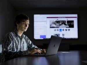 Analyst and programmer for UGA Libraries Josh Wier at his laptop with the Civl Rights Digital Library website in the background. Wier worked on a newly released version of the library’s digital interface for users.
